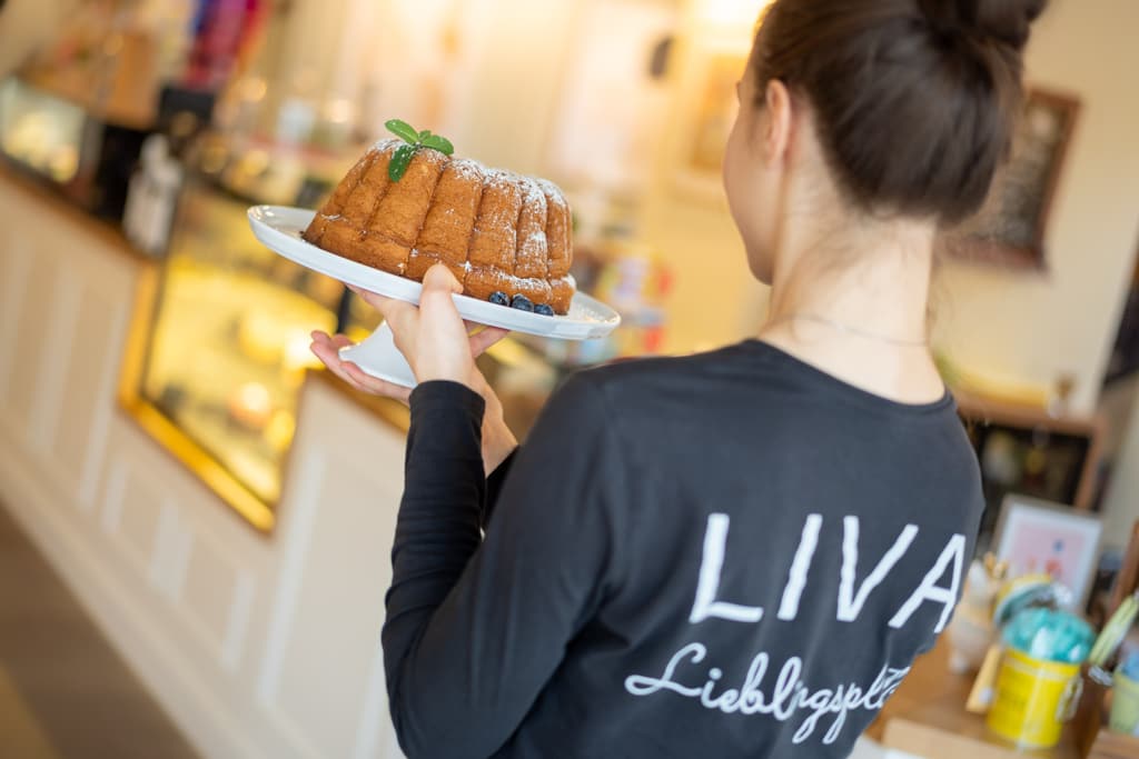 LIVA-Teammitglied serviert einen frisch gebackenen Gugelhupf